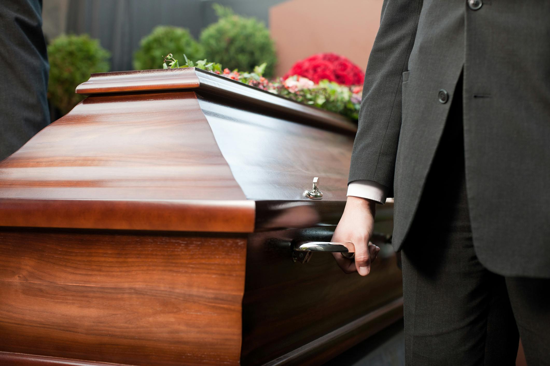 man carrying casket