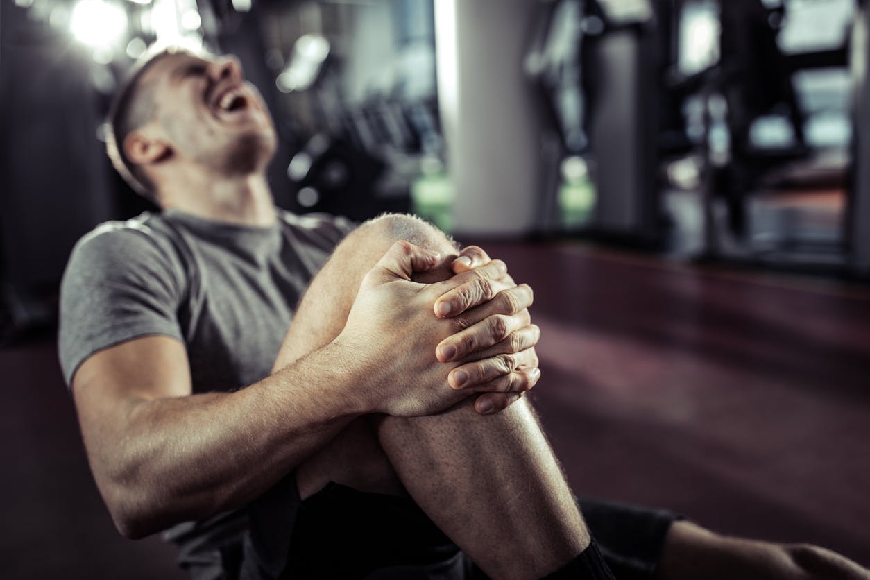 Man holding his leg in pain