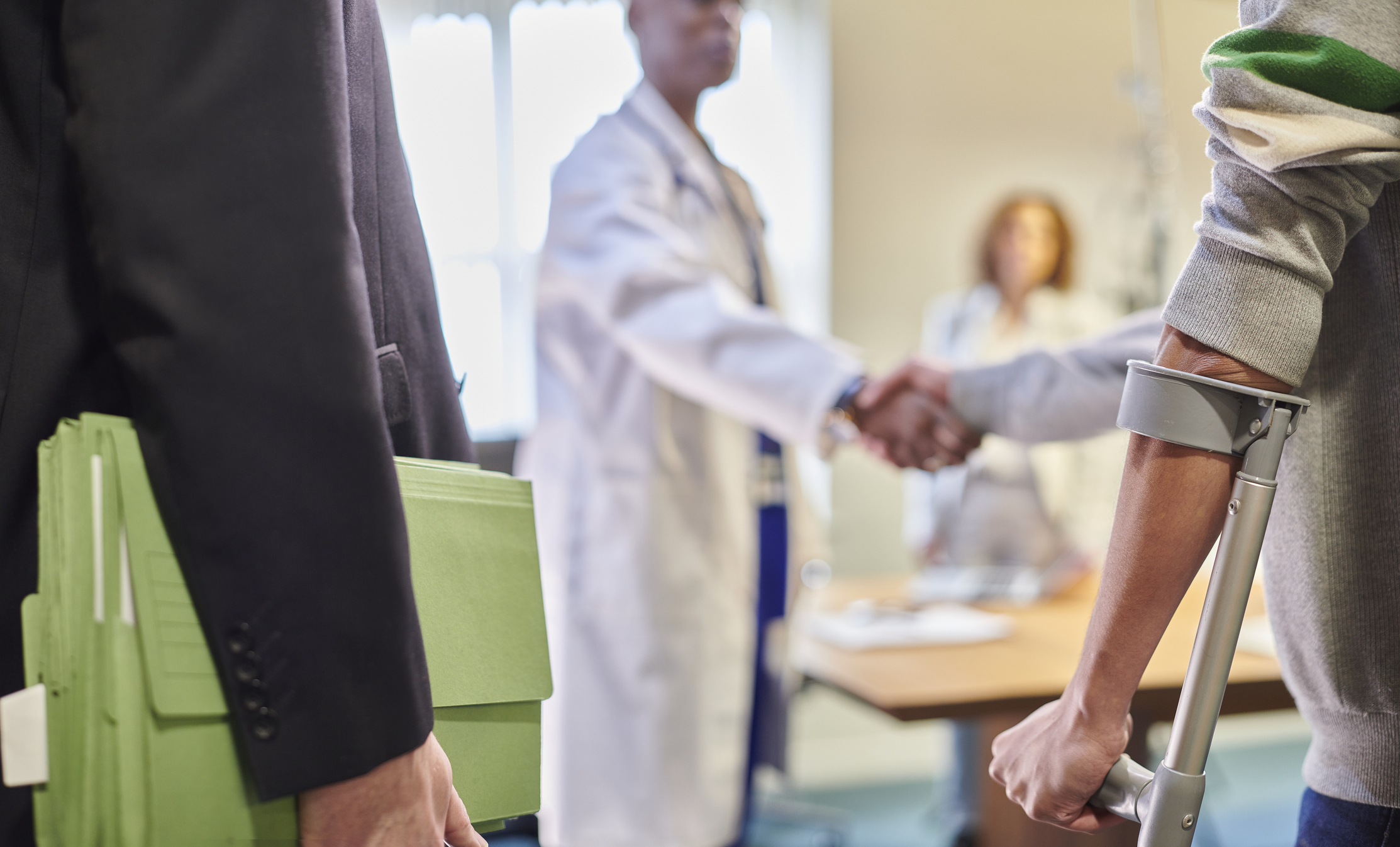 injured client with lawyer and doctor