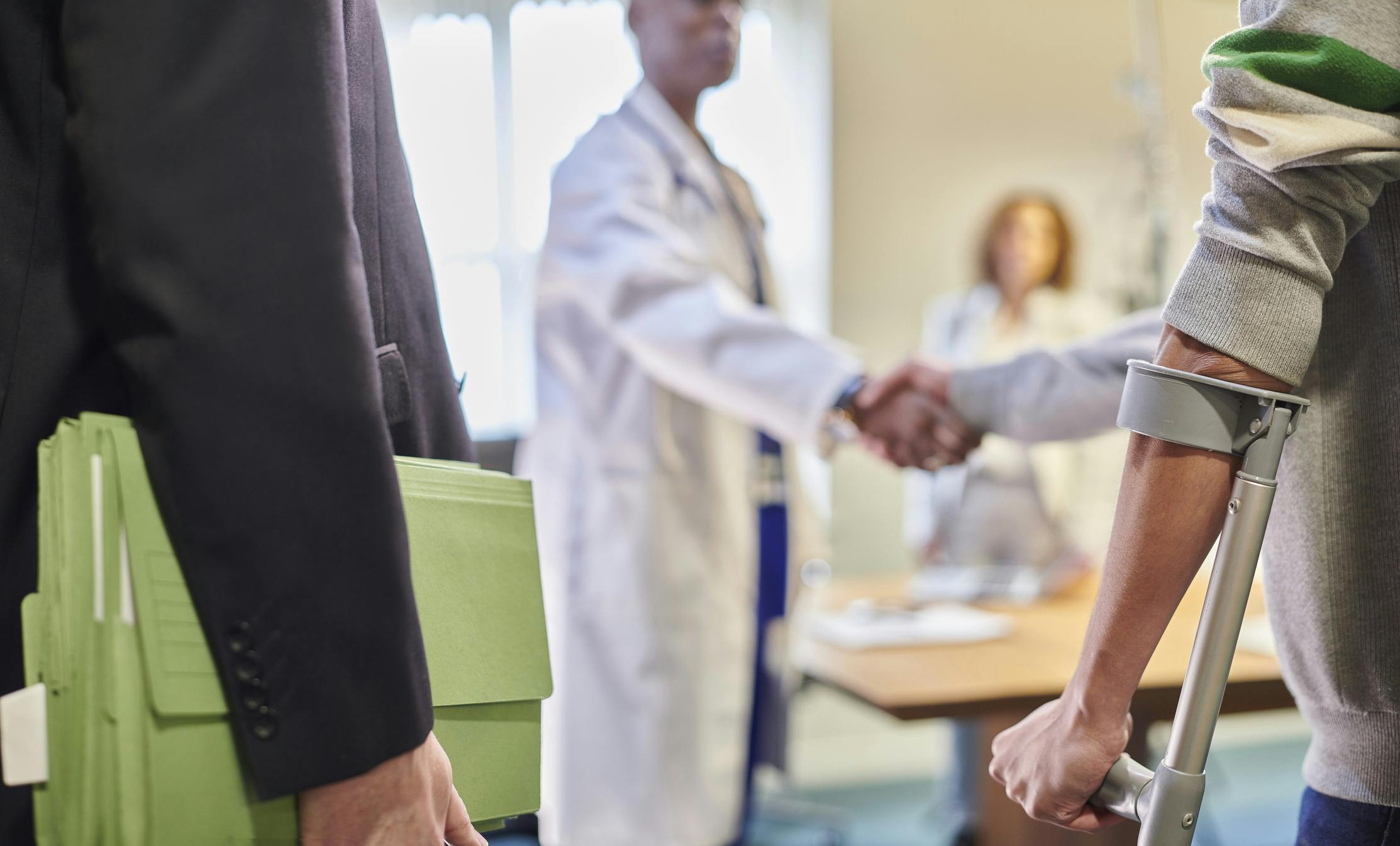 injured client with lawyer and doctor