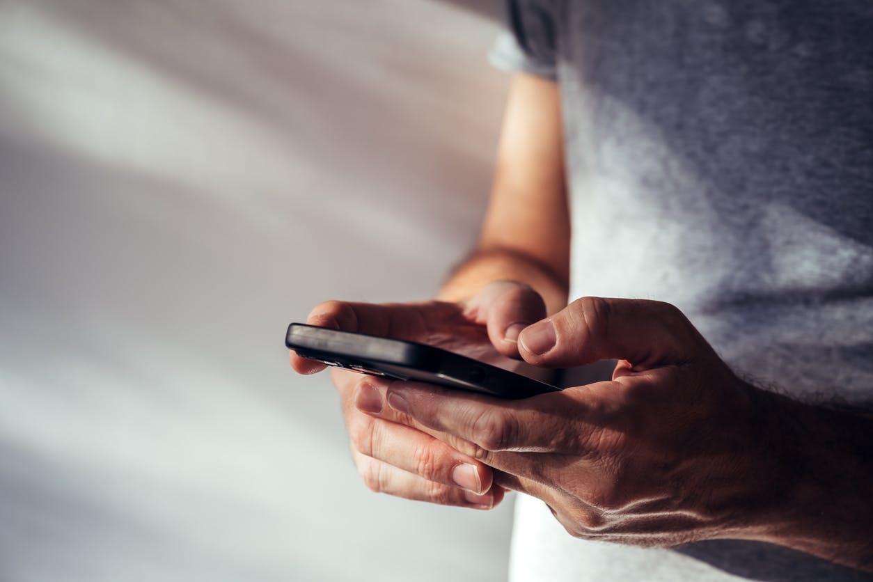 A man texting on a phone