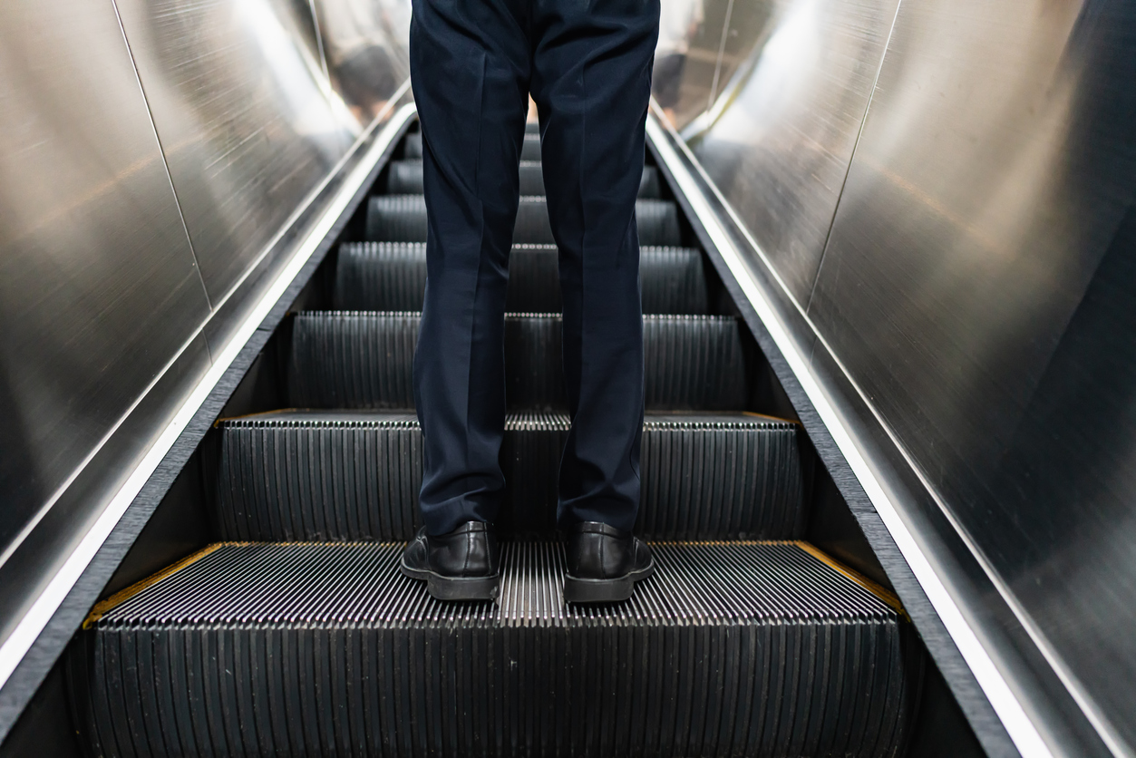 A person riding an escalator