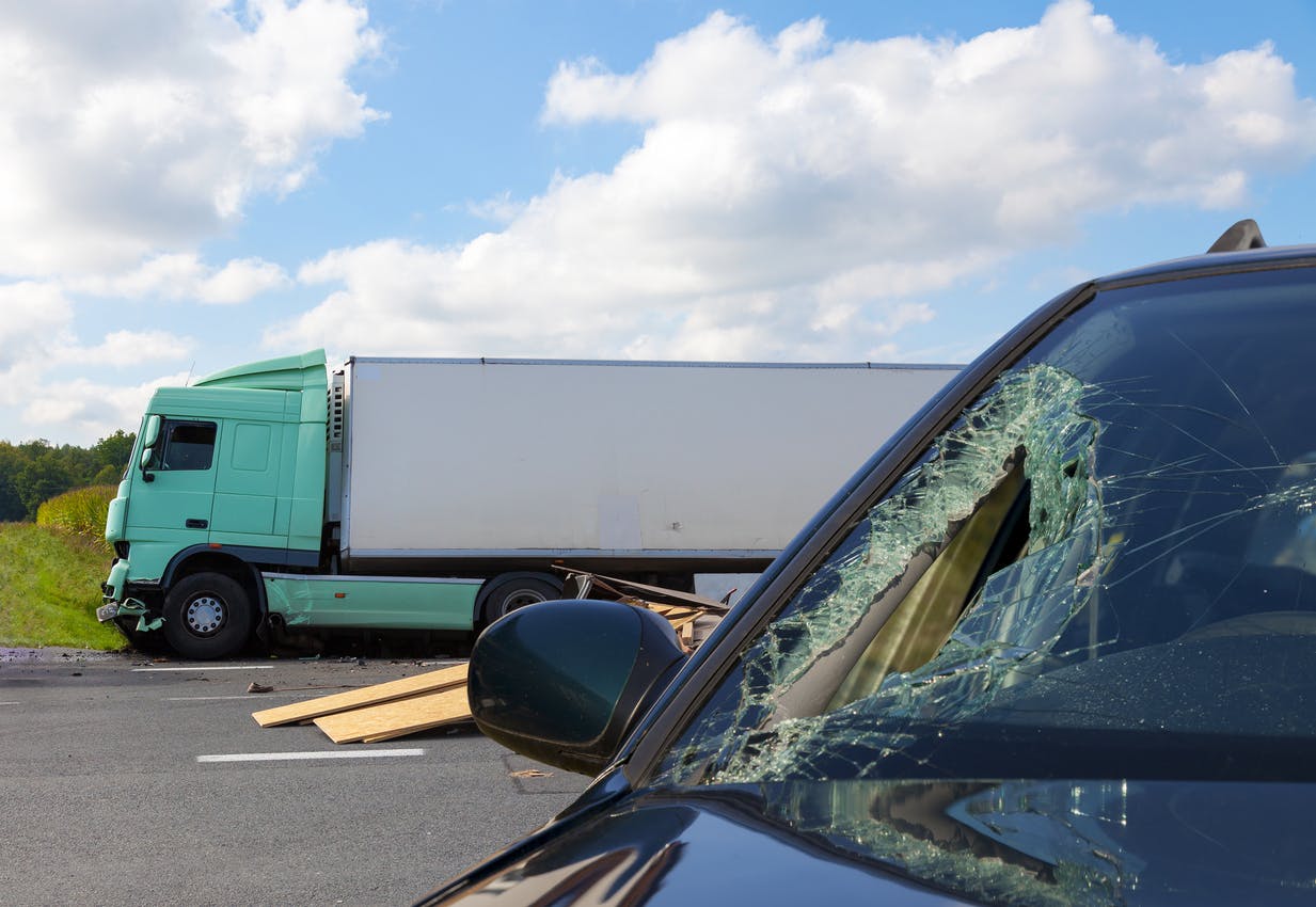 A semi truck that has crashed into a car