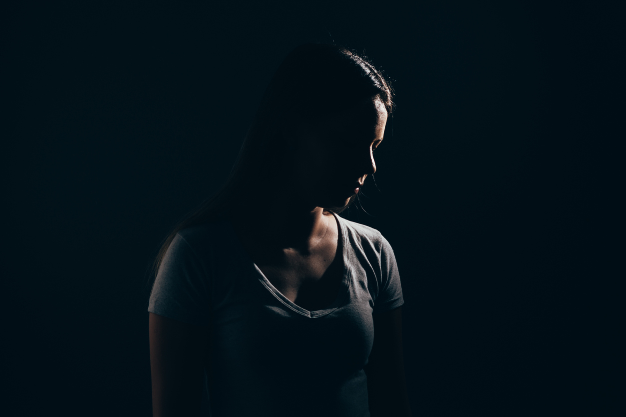 A woman standing in the dark