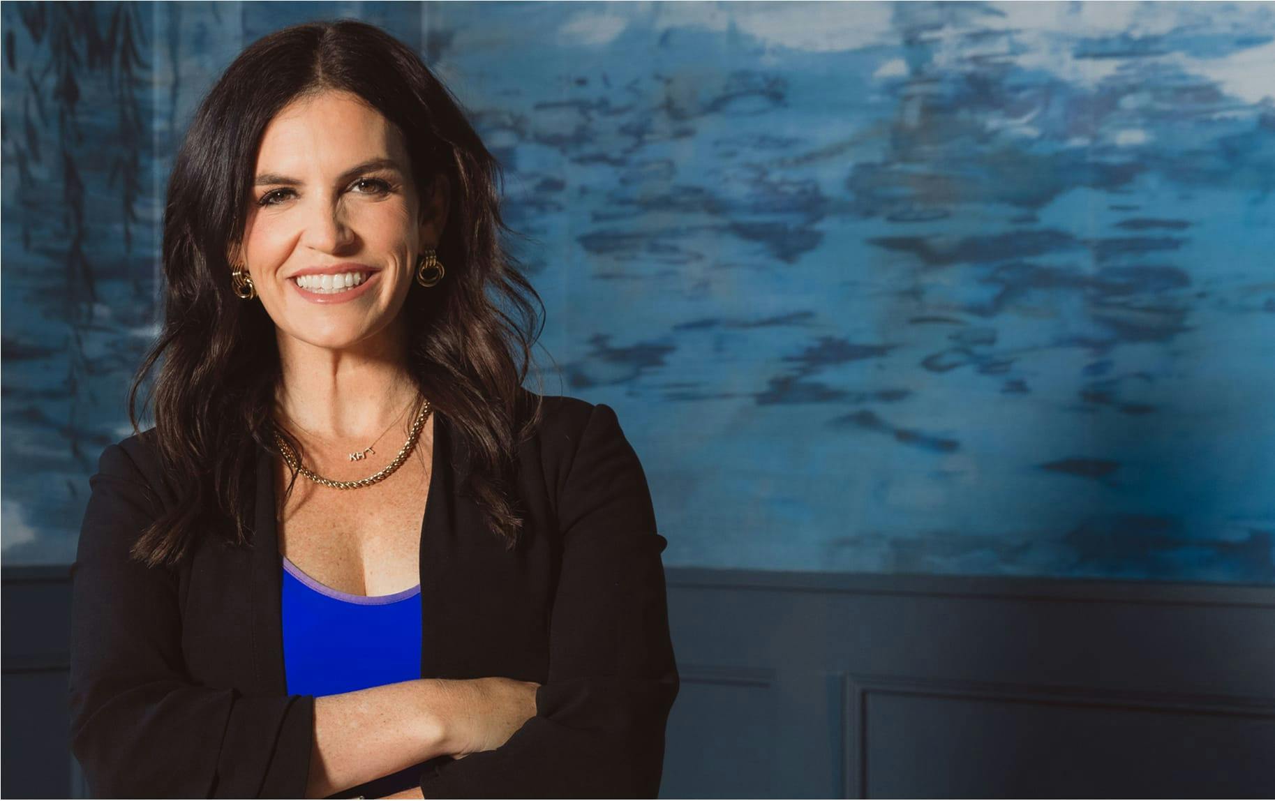 woman in black suit smiling