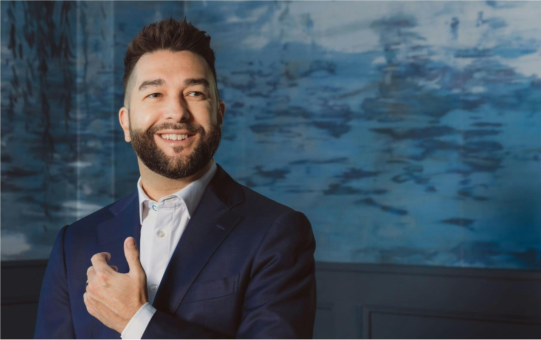 man in blue suit smiling