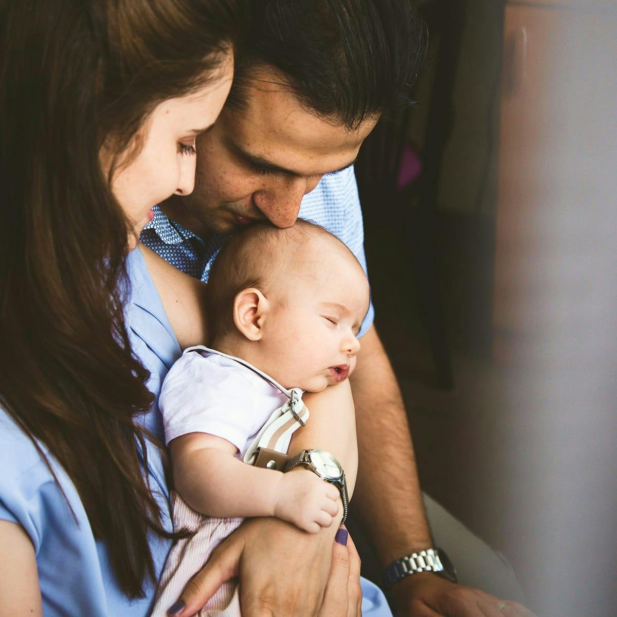 parents holding a baby