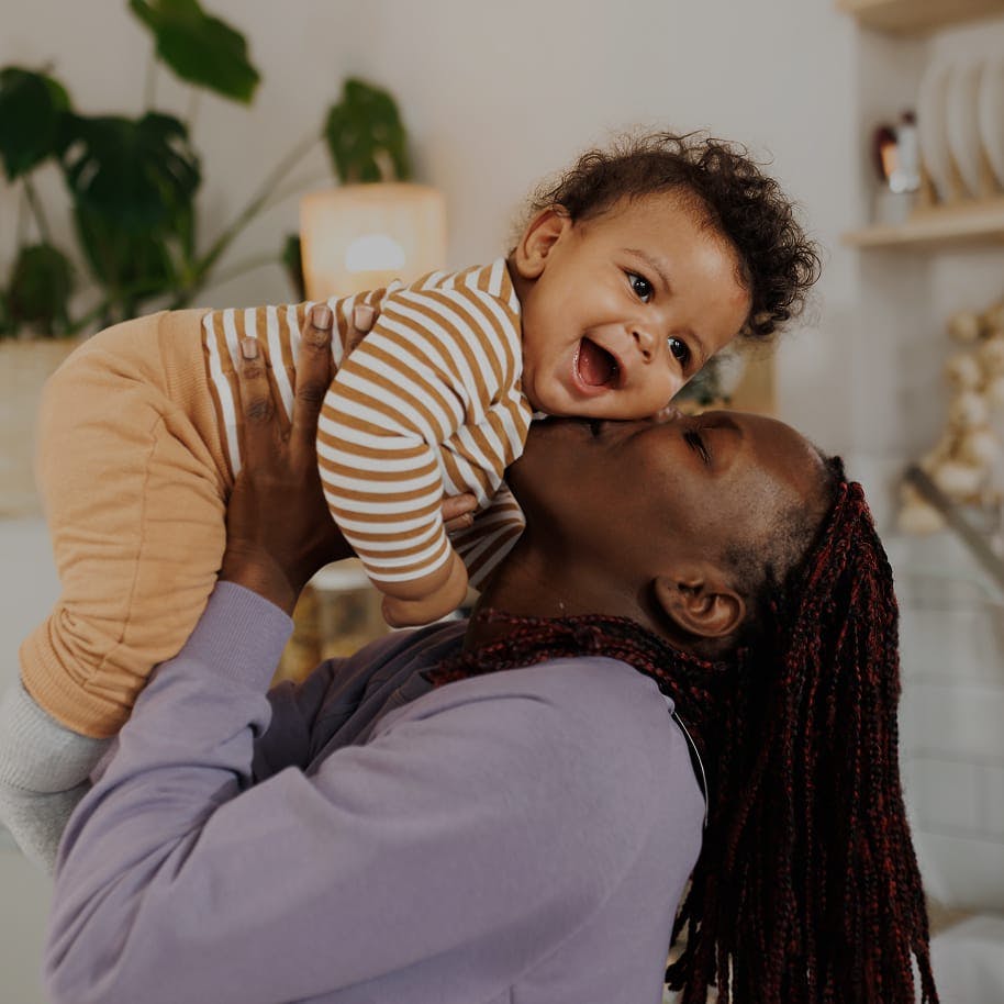 mother kissing baby