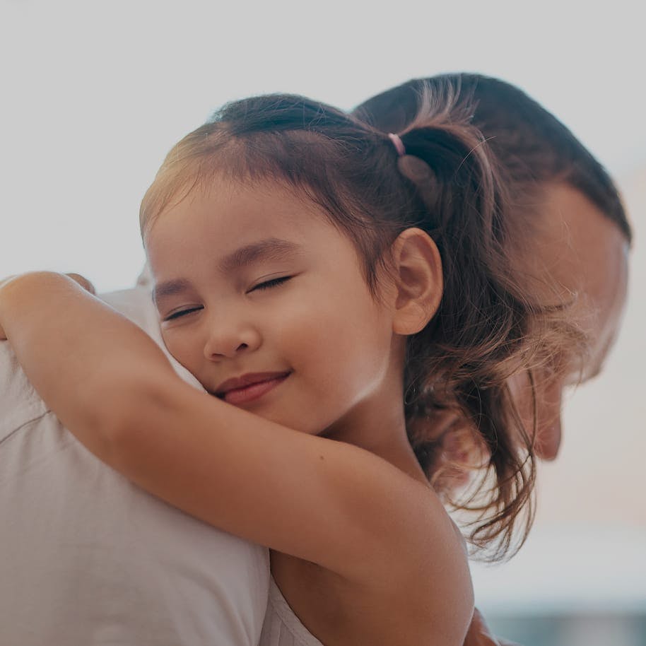 young girl hugging her dad