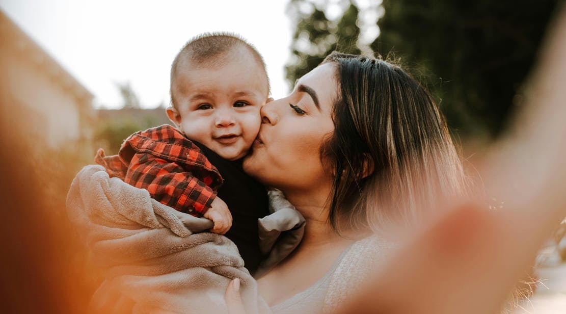 mother kissing son