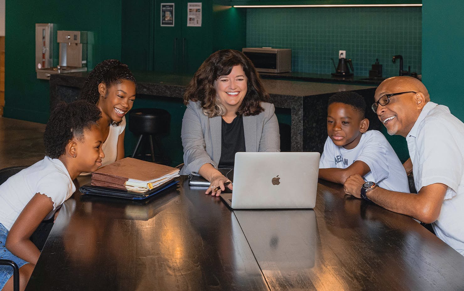 family smiling at laptop