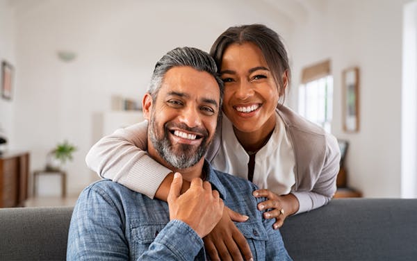 family smiling at father