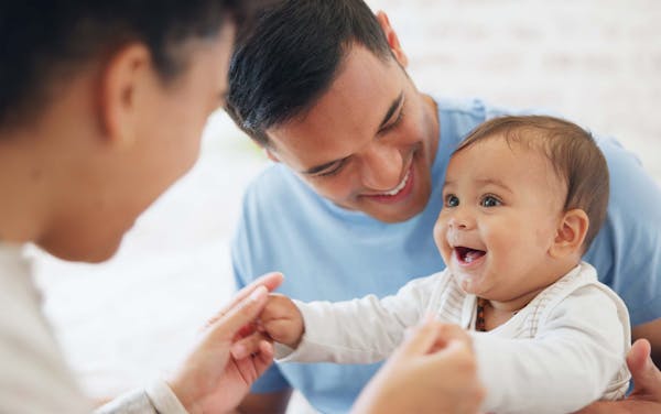 baby smiling at parents