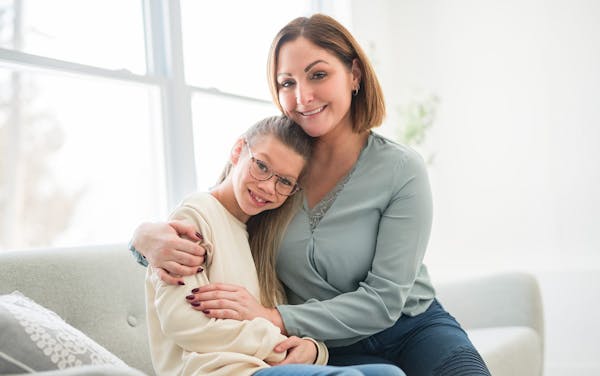 mother hugging daughter