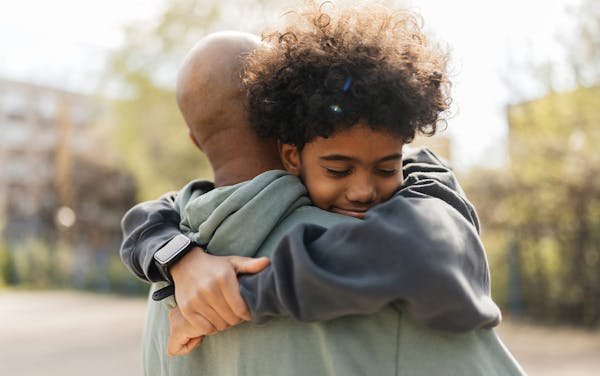 son hugging father