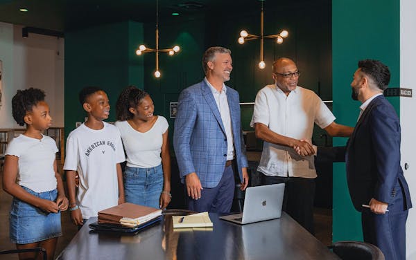 attorney shaking hands with clients