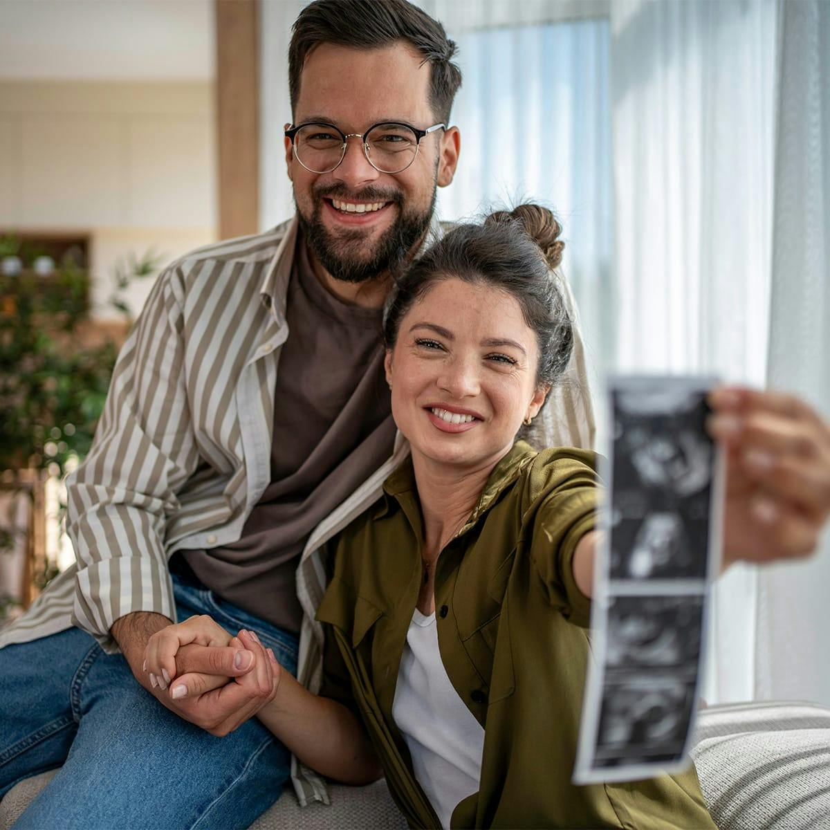 woman holding picture of ultrasound
