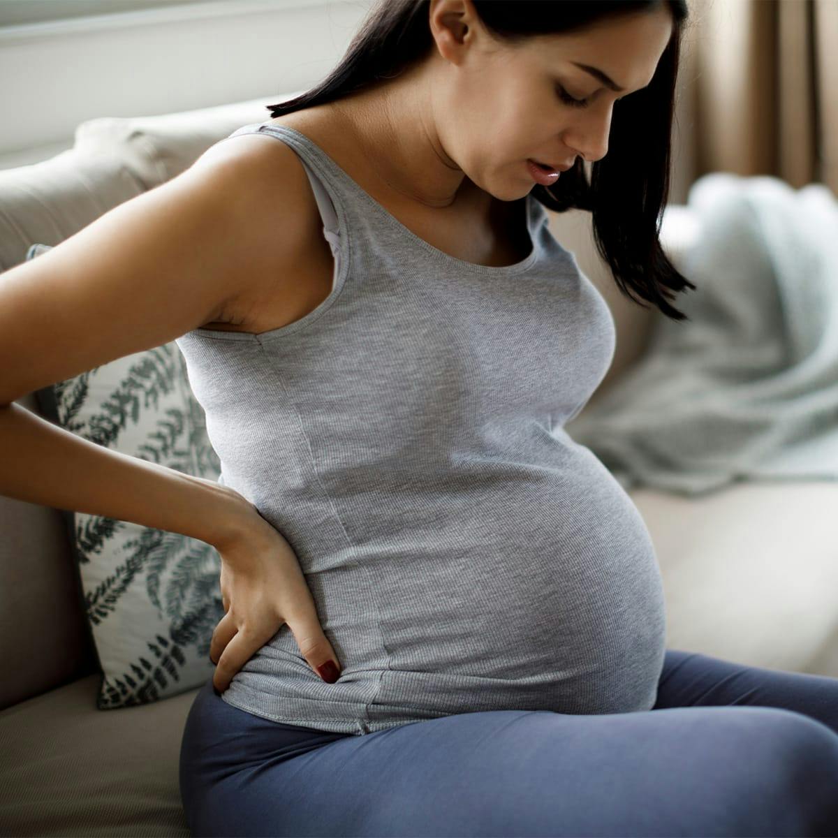 pregnant woman looking at stomach