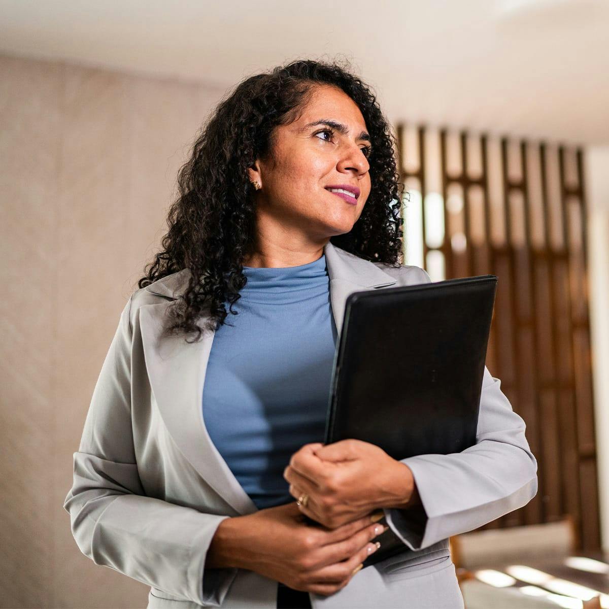 woman holding laptop smiling