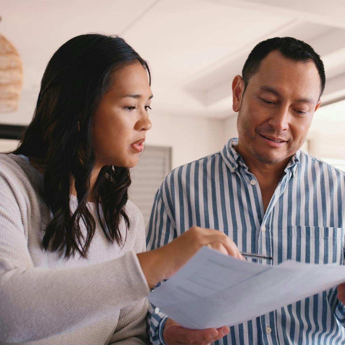 man and woman looking at paperwork