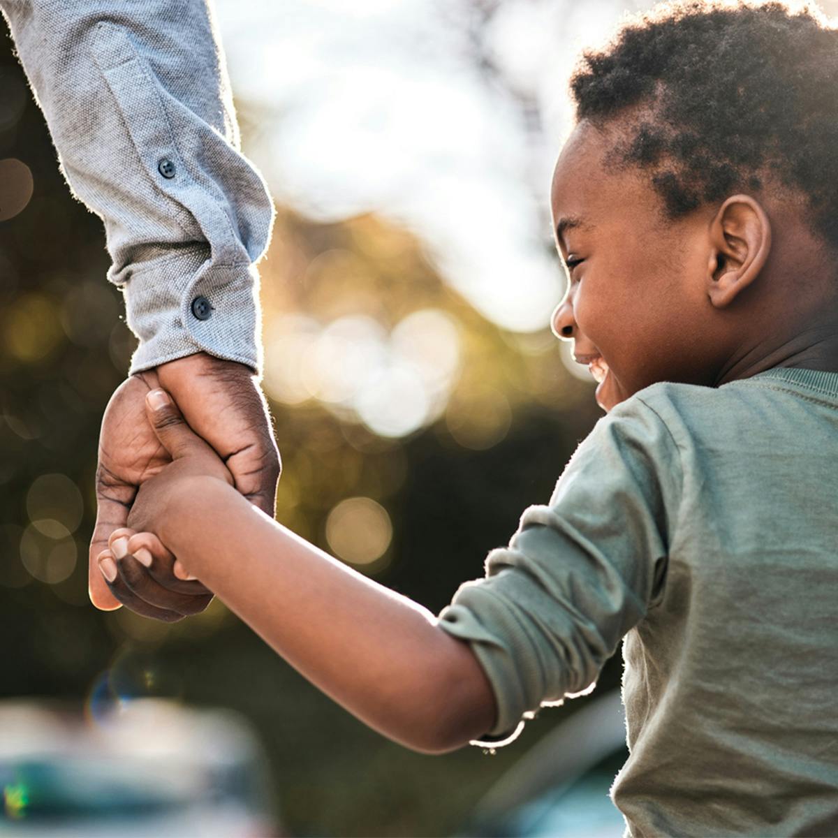 son holding father's hand