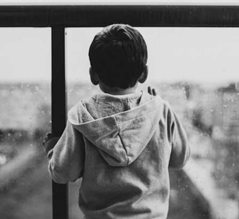 little boy looking out window