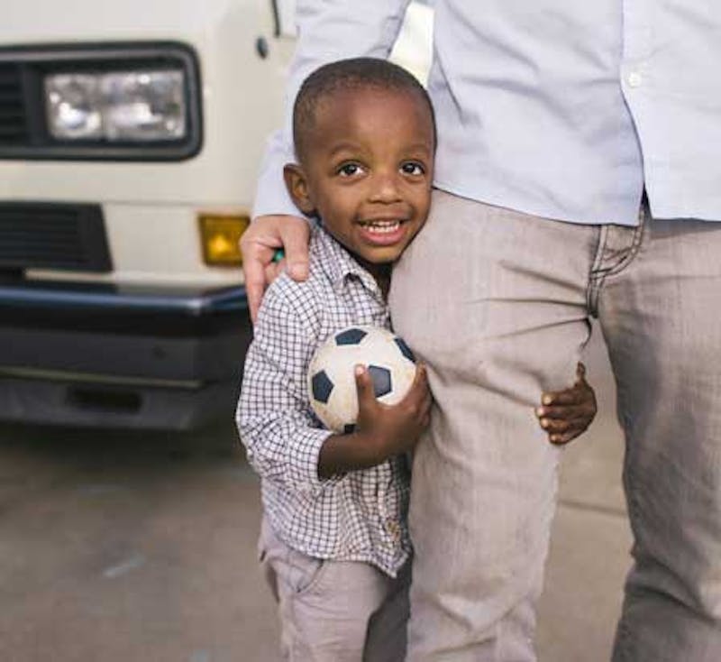 smiling boy holding soccer ball
