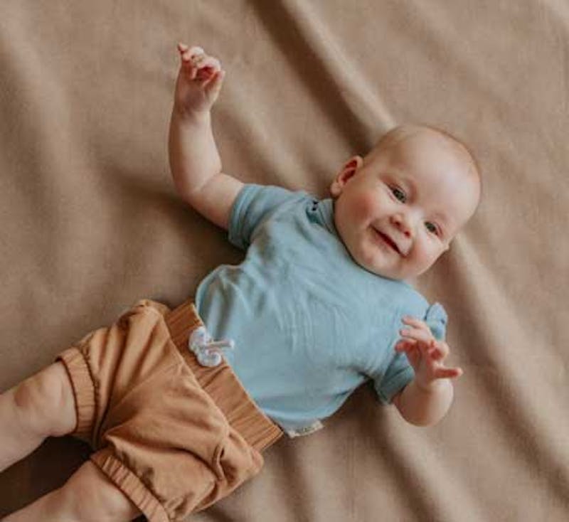 smiling baby on bed