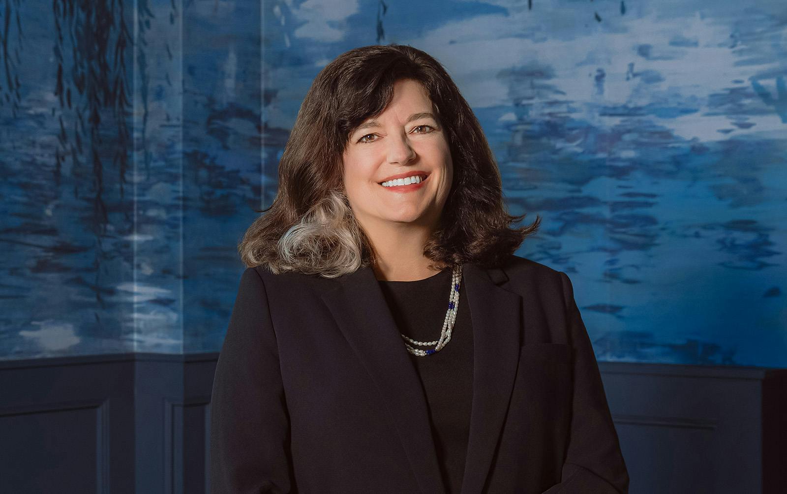 woman in blue suit smiling