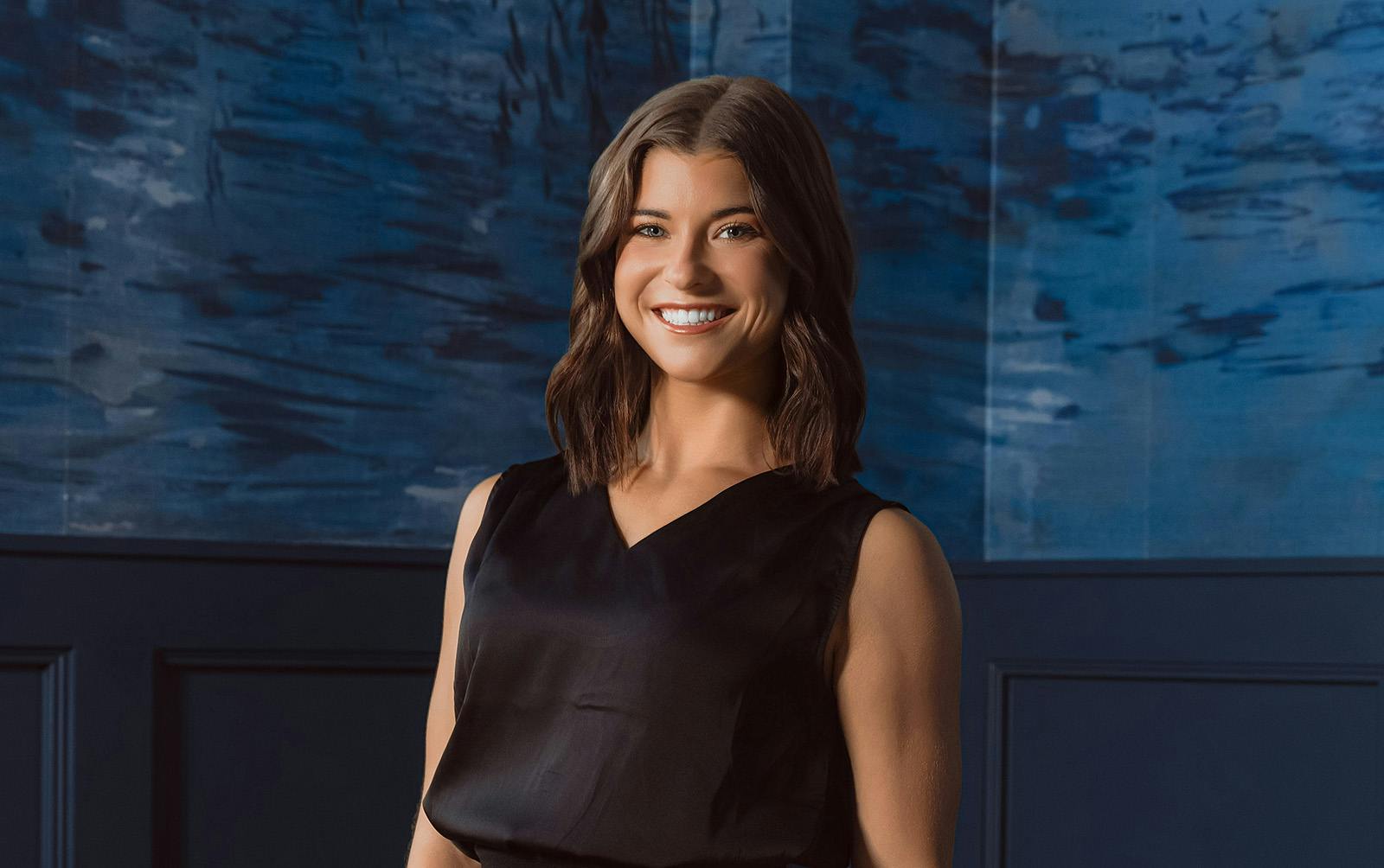 woman in black suit smiling