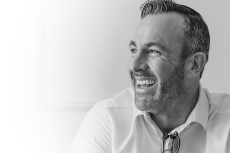 Handsome man smiling, looking to the side