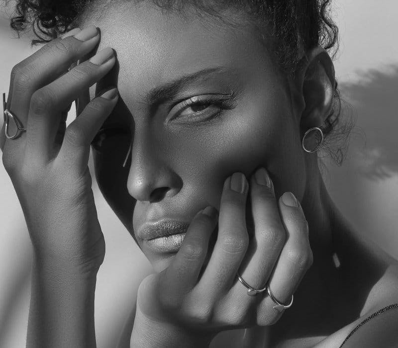 Woman touching her face with both hands