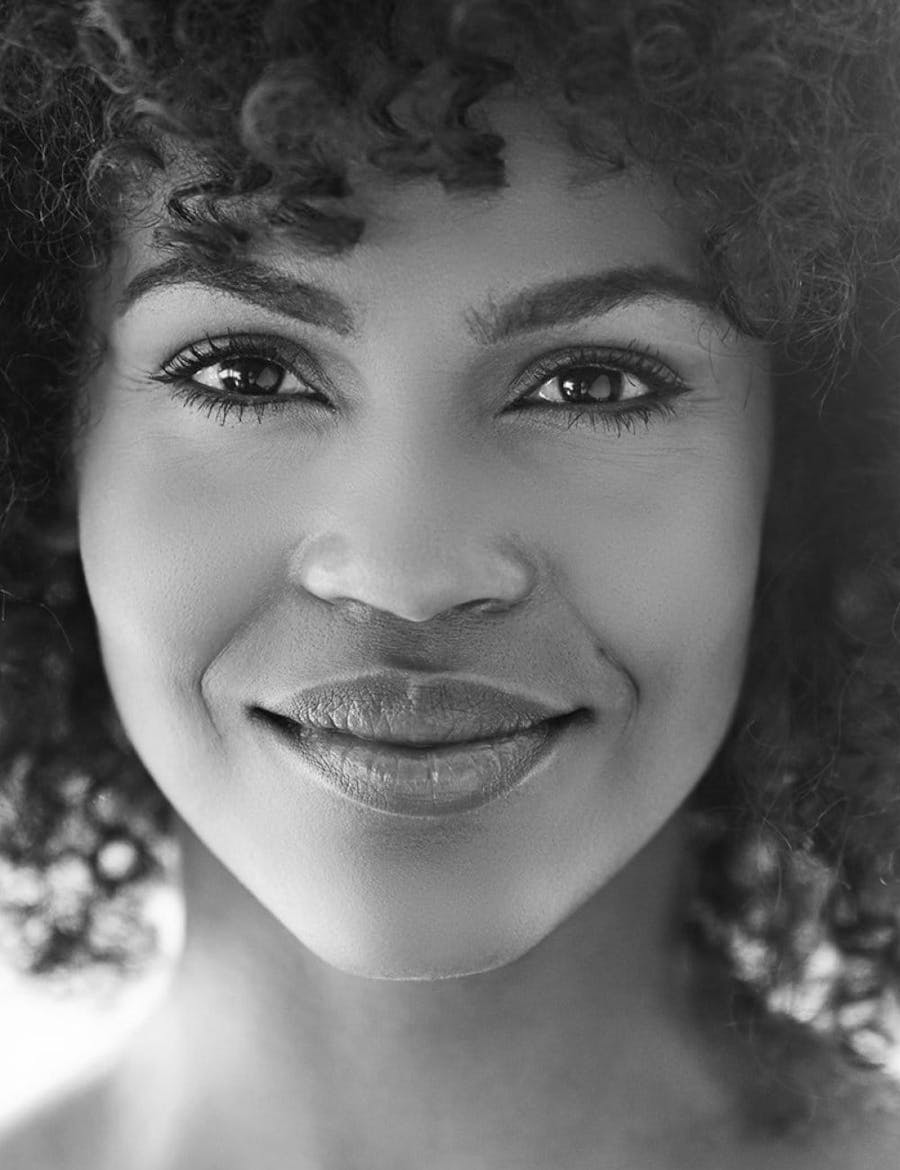 Face of a beautiful woman with curly hair.