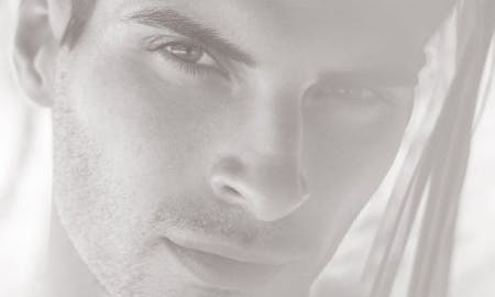 Close up of a man's stubbled face.