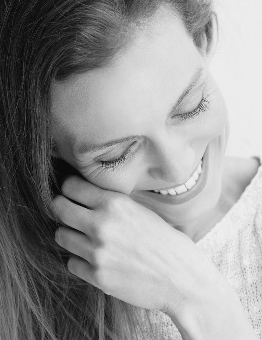 Woman smiling, looking down