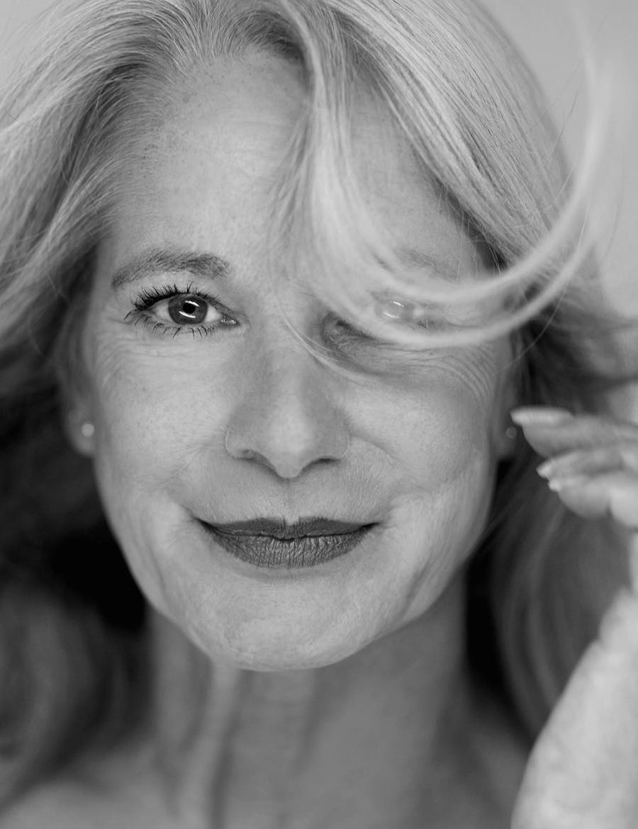 Older woman with some hair in her face.