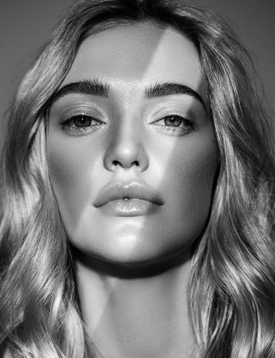 A shadowed woman's face with one line of light across it.