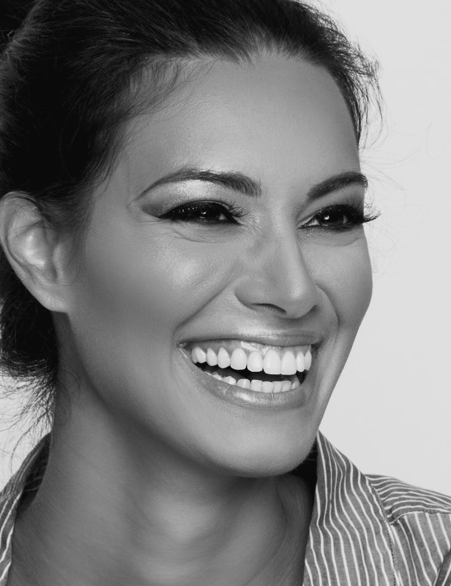 Woman smiling with glowing skin from microneedling