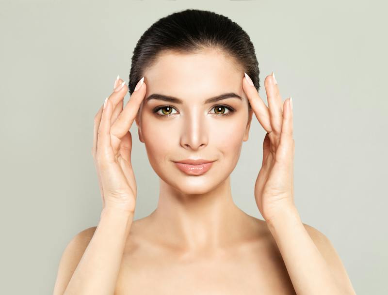 woman touching her face