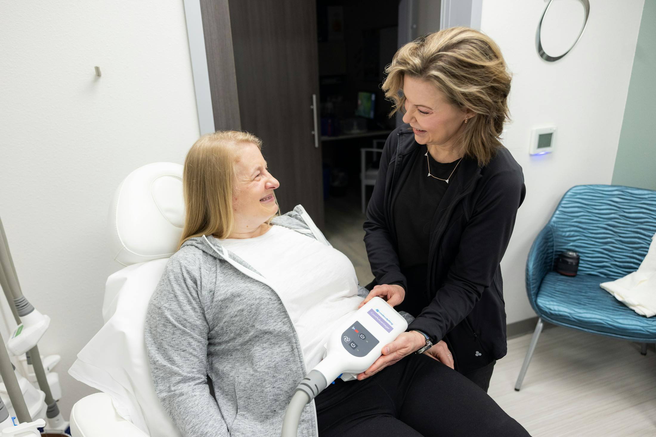 Women performing Coolsculpting on patient