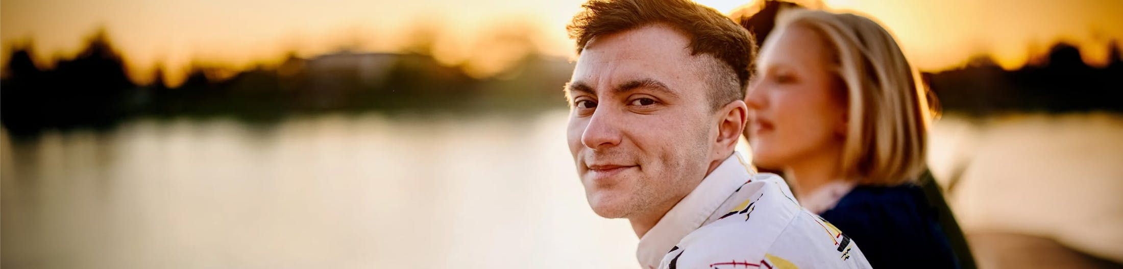 two people sitting by water