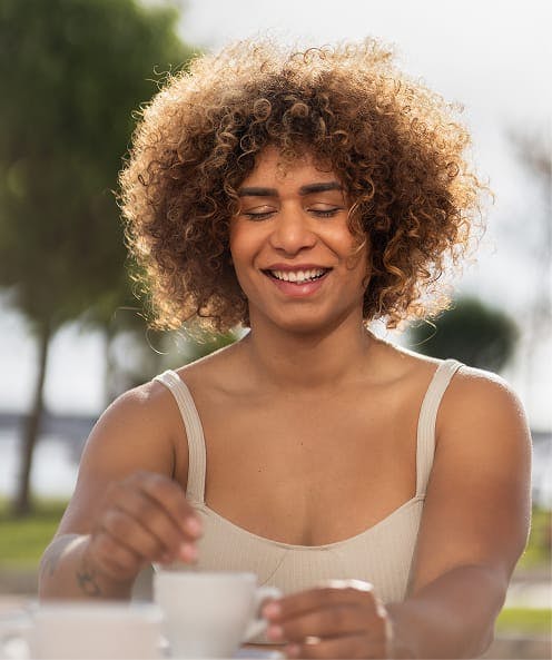 person stiring tea outside