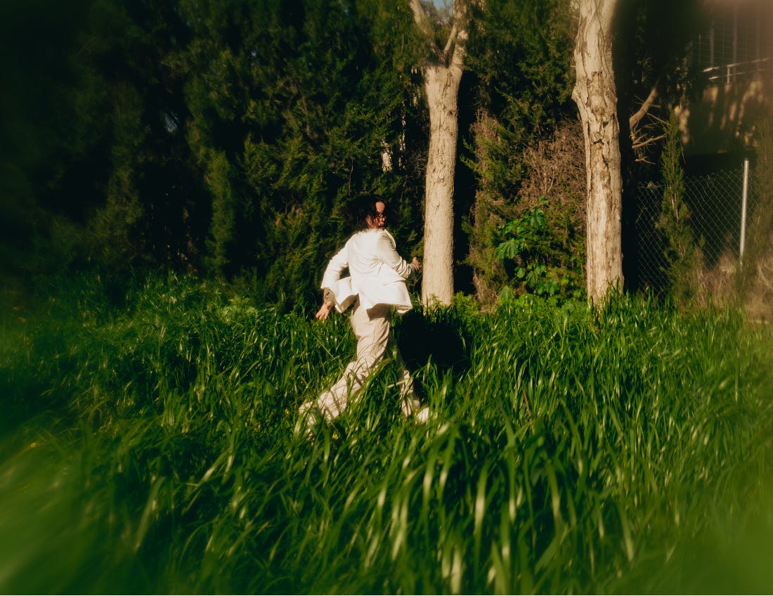 person walking through grass