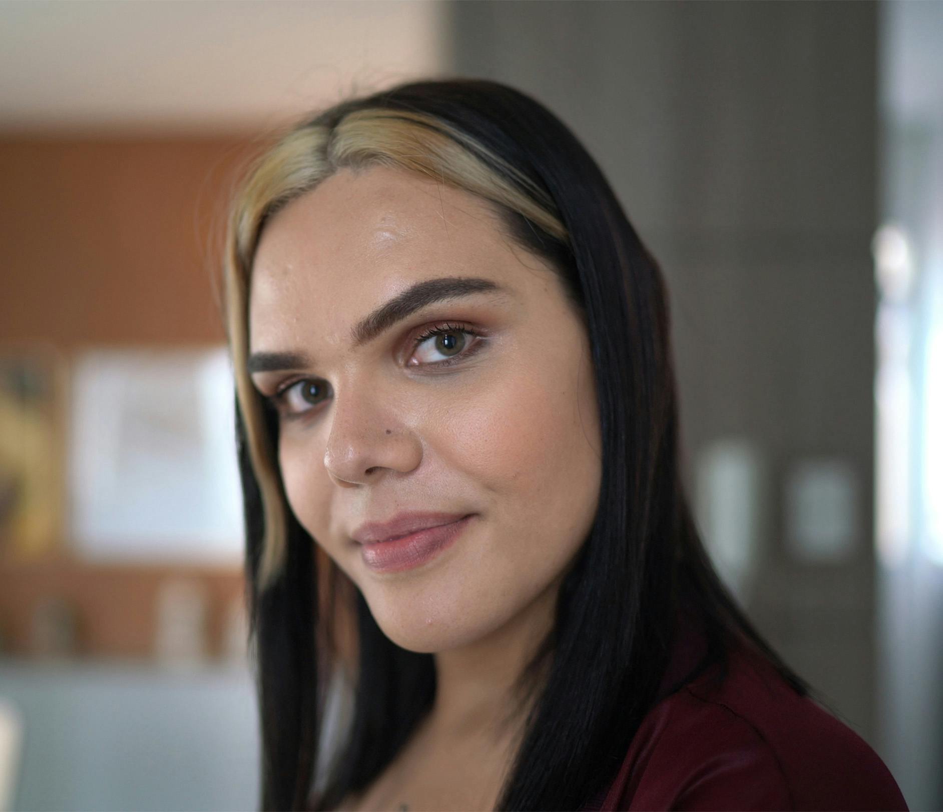 woman with dark hair with blonde streaks