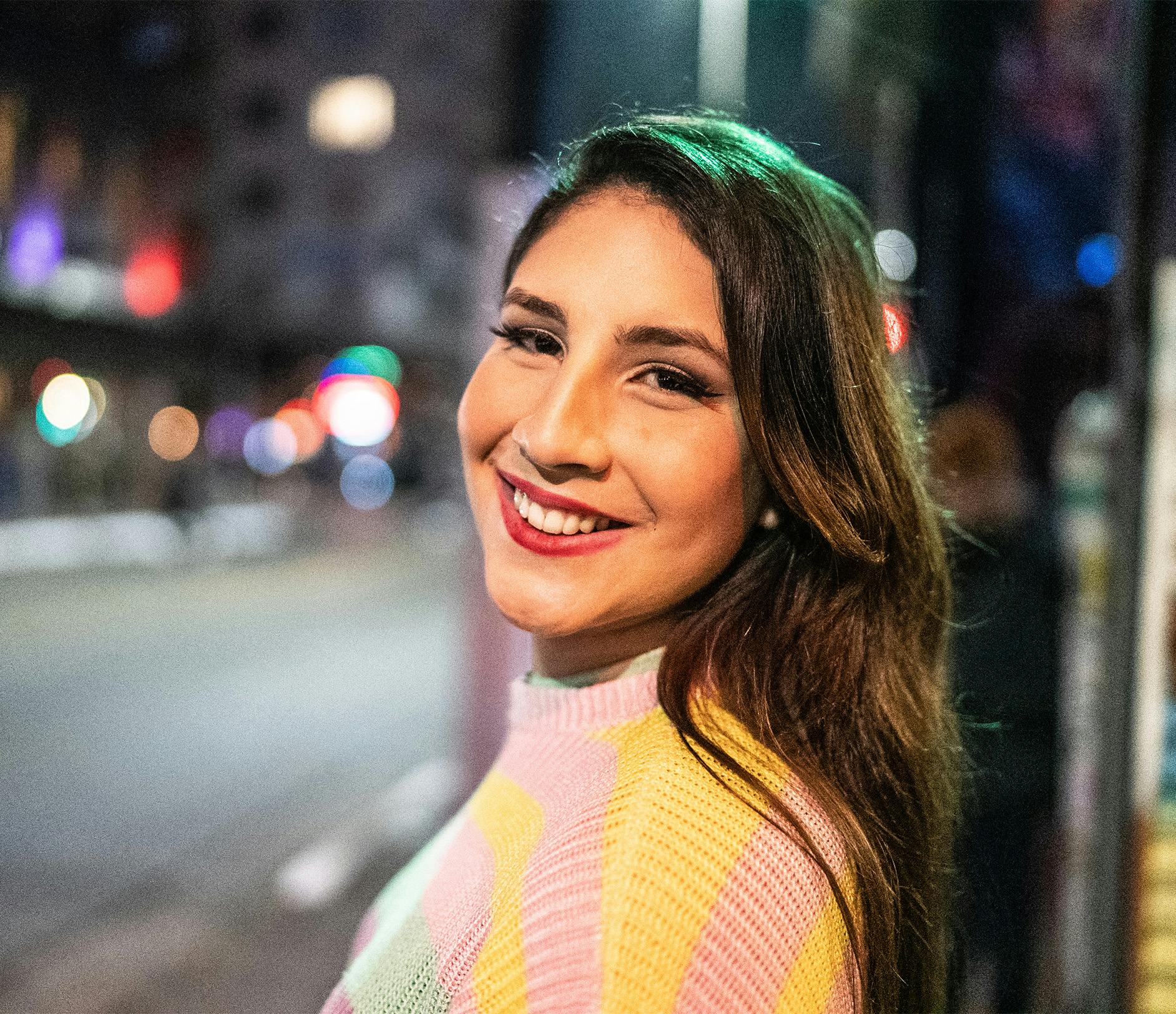 woman wearing a pink and yellow sweater