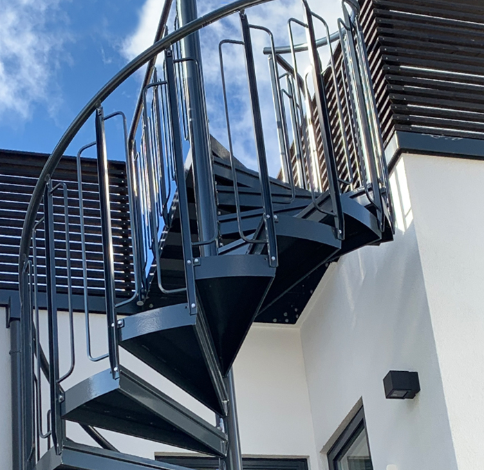 Schwarz pulverbeschichtete Spindeltreppe mit kindersicherem Geländer