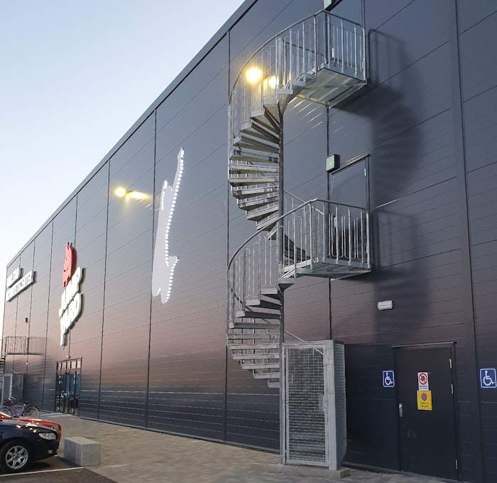 Galvanized spiral staircase outdoors with standard quarter cage