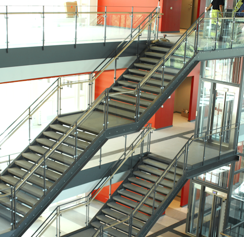 Glass railing with wooden inner handrail