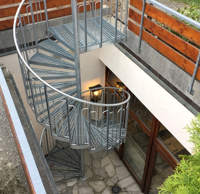 Spiral staircase with childsafe railing and steps of grating
