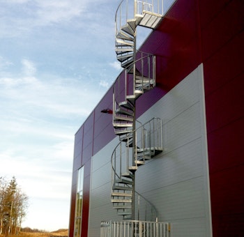 Spiral staircase standard outdoors with steps of grating